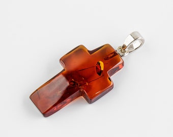 Natural Baltic Amber cognac color polished cross shape amber pendant. 925 silver.