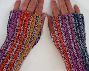 May include: A pair of striped fingerless gloves in shades of purple, orange, and gray. The gloves are crocheted with a sparkly yarn.