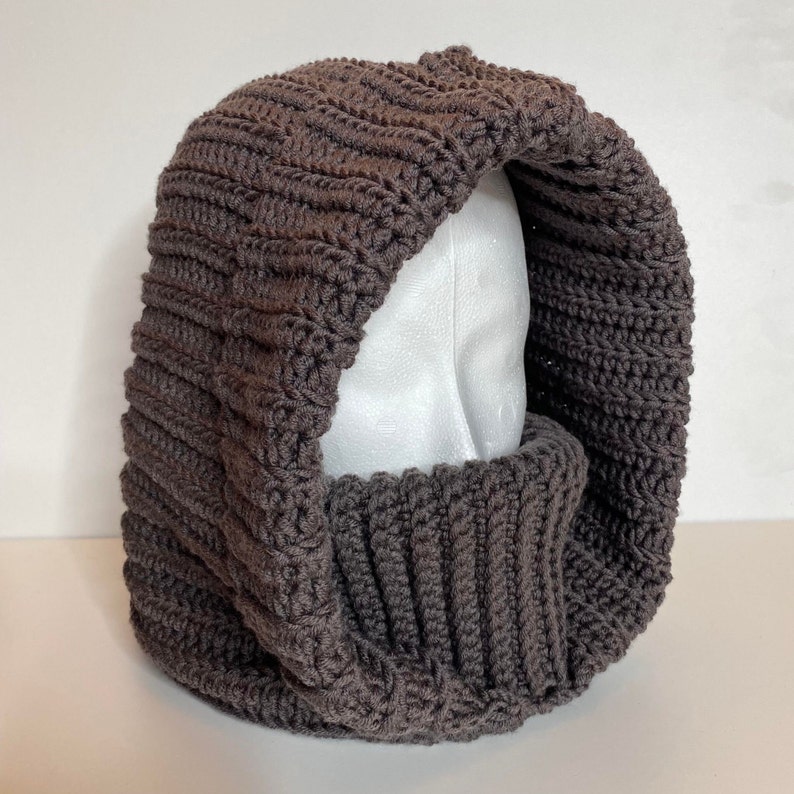 Turtleneck Hoodie Crocheted in brown Wool yarn on a styrofoam head.