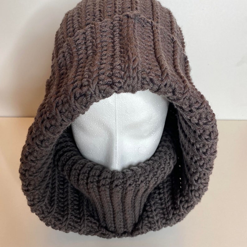 Turtleneck Hoodie Crocheted in brown Wool yarn on a styrofoam head.