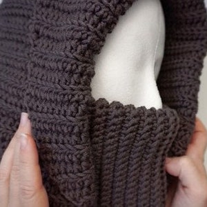 Turtleneck Hoodie Crocheted in brown Wool yarn on a styrofoam head.