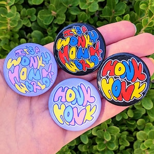 May include: Four colorful round buttons with the text "It's a wonky honk world!" and "Honk Honk" in a retro style font.