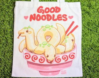 May include: White canvas tote bag with the text "GOOD NOODLES" in red letters and two pink hearts. The bag features a cartoon illustration of three yellow snakes in a pink bowl with red chopsticks.