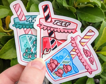 May include: Three colorful bubble tea stickers with different designs. Each sticker features a clear plastic cup with a straw, filled with colorful liquid and topped with tapioca pearls. The text "TEEF" is written on one of the stickers.