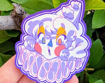 May include: A purple and white sticker of a cartoon character with a white hat, yellow eyes, and a pink face. The character is wearing a purple and white ruff.