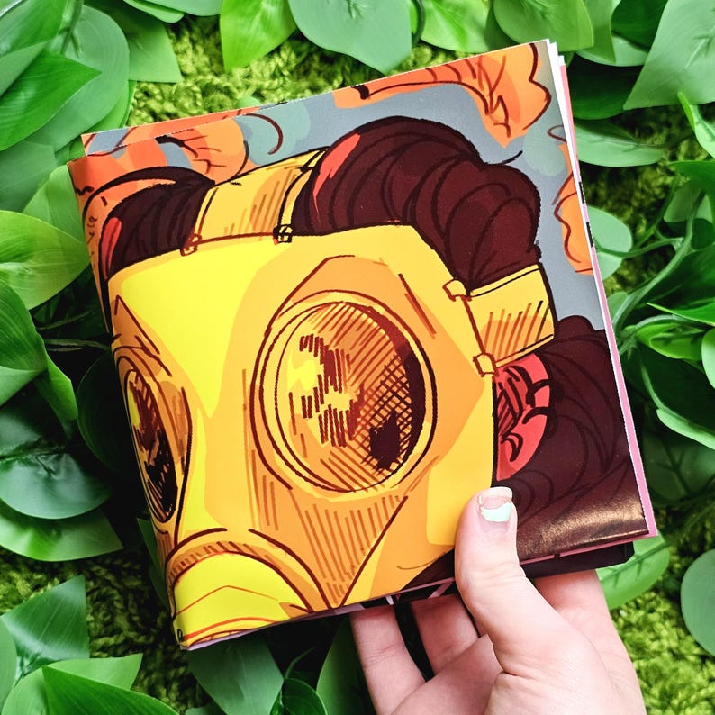 May include: A yellow gas mask with a brown strap and a red and brown background. The mask has a large, round, yellow lens with a black center.
