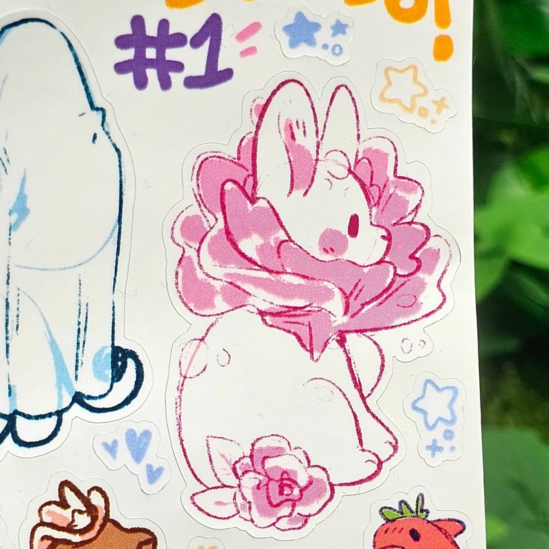 May include: A white rabbit with pink ears and a pink flower collar. The rabbit is sitting on a pink flower with a green stem. The rabbit is wearing a pink bow tie. The rabbit is surrounded by stars and hearts.