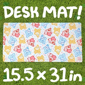 May include: A rectangular desk mat with a repeating pattern of cartoon clowns in red, blue, and yellow on a white background. The mat measures 15.5 x 31 inches and has the text "DESK MAT!" and "MILKY TOMATO" printed on it.