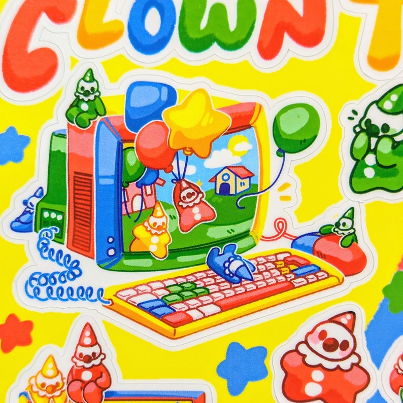 May include: A colorful computer monitor with a cartoon scene inside. The monitor is surrounded by cartoon clowns, stars, and balloons. The computer has a keyboard with colorful keys. The text "CLOWN" is at the top of the image.
