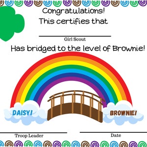 May include: A Girl Scout bridging certificate with a rainbow and a bridge. The certificate says "Congratulations! This certifies that Girl Scout has bridged to the level of Brownie!" with the words "DAISYI" and "BROWNIE!" on clouds at the bottom of the rainbow.