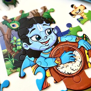 May include: A colorful jigsaw puzzle featuring a cartoon illustration of Krishna, a Hindu deity, playing a drum. The puzzle piece shows Krishna in a blue outfit with a yellow sash, holding a brown drum with a white substance inside. The background is a green forest scene with a peacock feather.