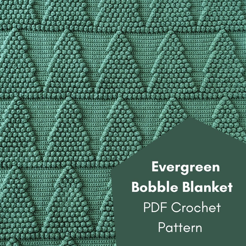 May include: A crochet pattern for an evergreen bobble blanket. The pattern is available as a PDF download. The image shows a close-up of the blanket, which is made with a repeating triangle pattern.