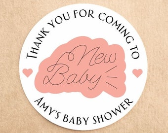 May include: Round white sticker with black text that says "Thank you for coming to Amy's Baby Shower".  The sticker has a pink cloud with black text that says "New Baby" and two small pink hearts.