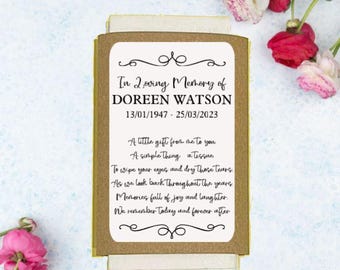 May include: A tissue box with a gold background and a white label. The label has a black border and says "In Loving Memory of DOREEN WATSON 13/01/1947 - 25/03/2023". The label also has a poem about remembering someone.