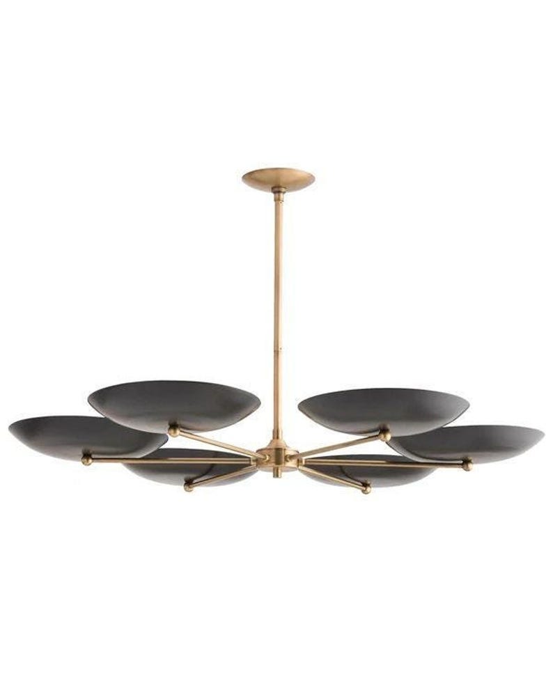 A profile view of the brass sputnik chandelier with six dark saucer-shaped shades and a vertical drop rod.