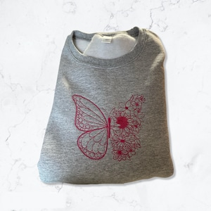 Pink butterfly embroidered Crewneck sweatshirt.