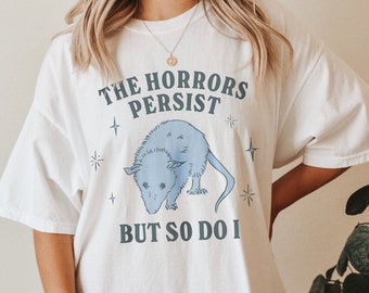 Gli orrori persistono, ma anche io divertente salute mentale Meme camicia ansia Tee Oppossum regalo Coquette Fairycore Weirdcore camicie che vanno duro