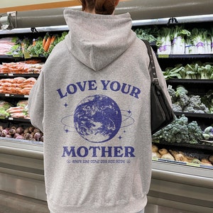 May include: Gray hooded sweatshirt with a blue graphic of the Earth and the text "Love Your Mother" and "She's the only one you have".
