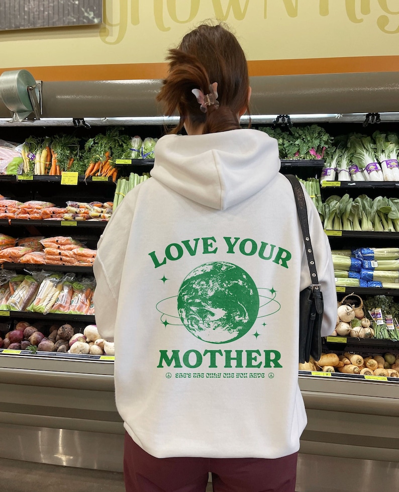 May include: White hoodie with a green graphic of the Earth and the text "Love Your Mother" and "She's the only one you have".