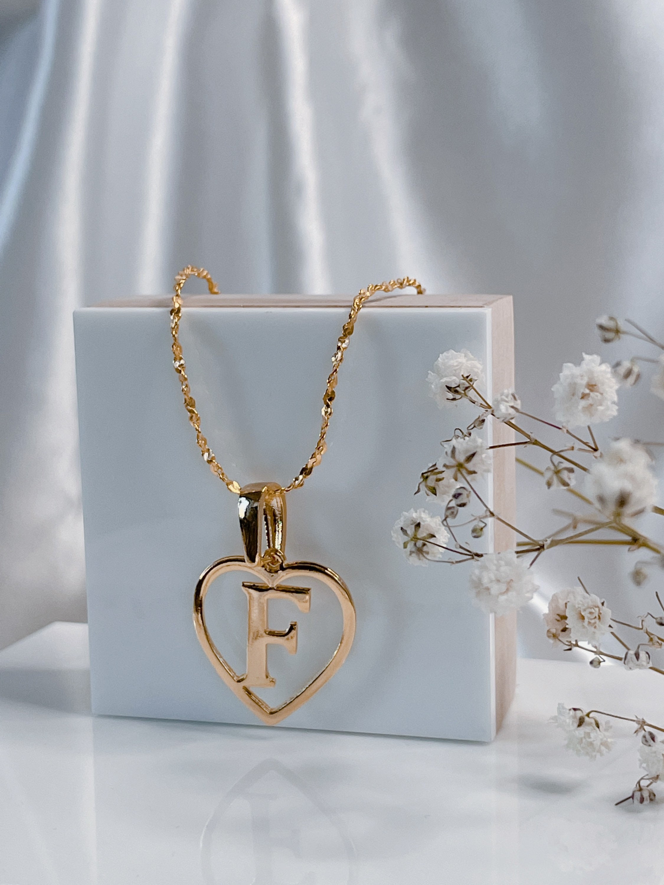 Heart necklace with letter inside discount