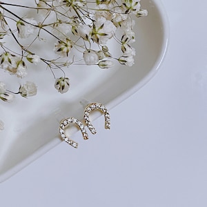 Tiny horseshoe stud earrings 14k gold plated with crystals.