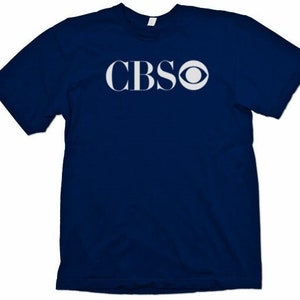 May include: A navy blue t-shirt with the CBS logo in white.