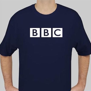 May include: Navy blue t-shirt with the white letters "BBC" in a block font. The letters are inside of three white squares. The shirt has short sleeves and a crew neck.