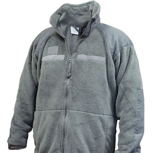 May include: A gray fleece jacket with a zipper closure and two pockets. The jacket has a high collar and a patch on the left chest.