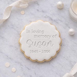 May include: A white ceramic mug with a black handle and the text "But First, Coffee" in a handwritten style. The mug is on a white surface. The mug is approximately 4 inches tall.