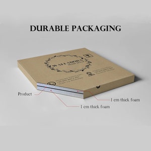 May include: A brown cardboard box with the text "DURABLE PACKAGING" and the brand name "WALL ADORA". The box has two layers of 1 cm thick foam for product protection. The box is designed for shipping.