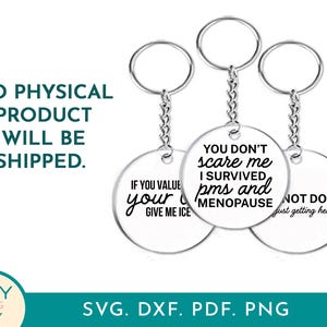 May include: Three round silver keychains with humorous phrases in black text. One says "If you value your give me ice", another reads "You don't scare me I survived pms and menopause", and the third says "Not done just getting heated."