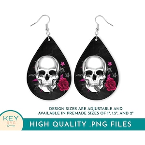 May include: A pair of black teardrop-shaped earrings with a silver skull design and a pink rose. The skull is biting a stem with a leaf. The earrings are available in 1 inch, 1.5 inches, and 2 inches.