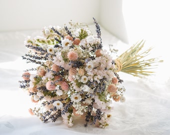 May include: A bouquet of dried flowers in shades of white, pink, and lavender. The bouquet includes dried lavender, baby's breath, and other small flowers.
