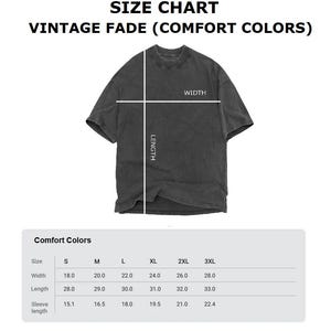 May include: A size chart for Vintage Fade Comfort Colors t-shirts. The chart displays measurements for width, length, and sleeve length in inches for sizes S through 3XL. The t-shirt in the image is a dark gray color.