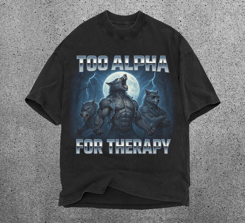 May include: Black t-shirt featuring a graphic of three werewolves under a full moon with lightning. The text "TOO ALPHA FOR THERAPY" is displayed above and below the illustration. The shirt has a vintage, distressed look.