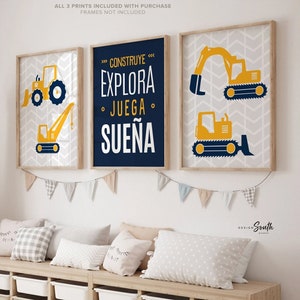 May include: Three framed prints with a blue and yellow color scheme. The prints feature yellow construction vehicles and the Spanish text "Construye, Explora, Juega, Sueña".