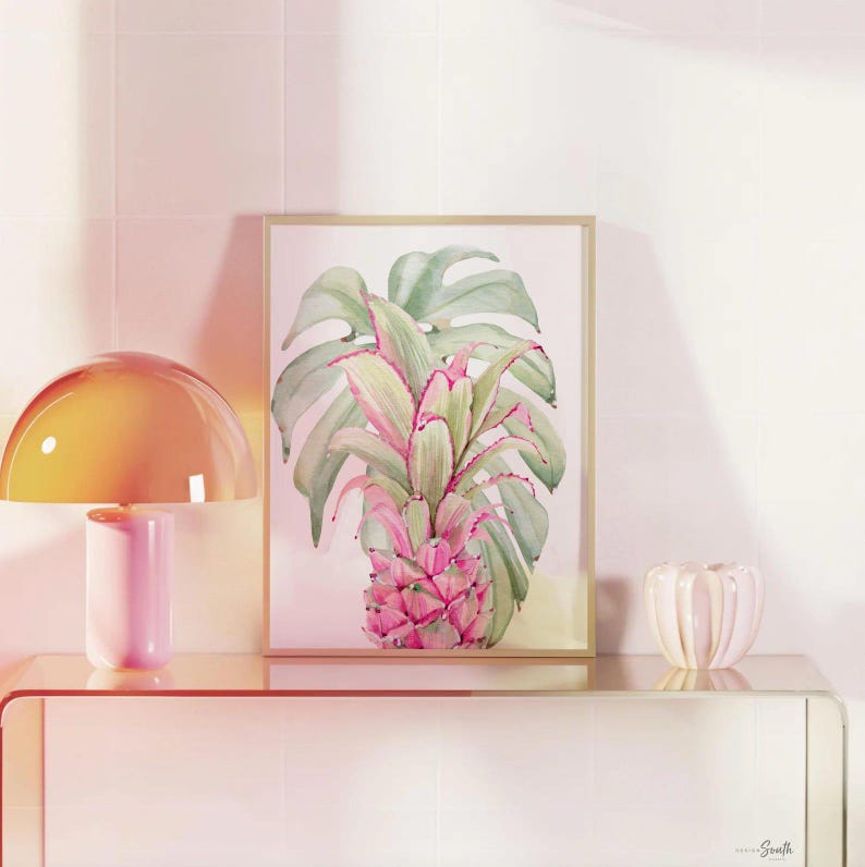 May include: Three framed prints with a tropical theme. The prints feature pink flamingos, green monstera leaves, and a pink pineapple. The center print has a pink quote that reads 'Be who God created you to be & you will set the world on fire.' The quote is attributed to St. Catherine of Siena.