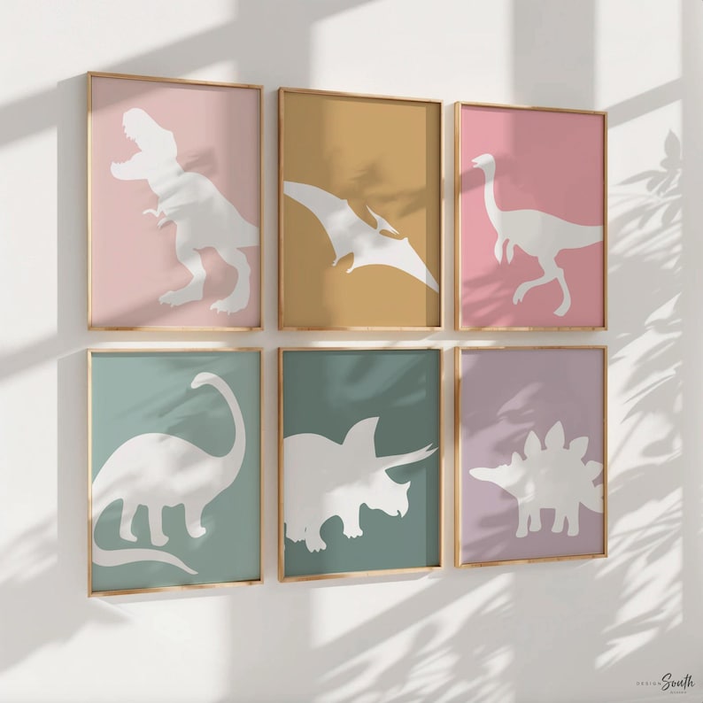 Adorable dinosaur art prints designed for a little girls room, featuring playful dinosaurs in shades of pink, teal, and purple. These vibrant and fun dinosaur illustrations are perfect for adding a touch of adventure and charm to toddler wall decor. Ideal for a girl's nursery, bedroom, or playroom, these art prints create a whimsical and colorful space. Perfect for girls who love dinosaurs, this wall decor adds personality and joy to any room setting, making it a delightful addition to her space