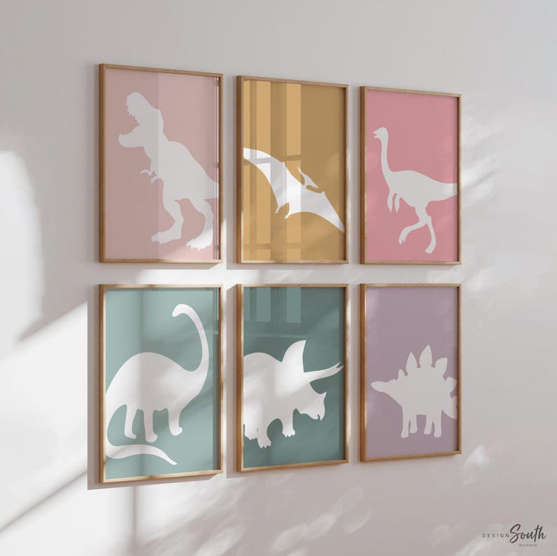 Adorable dinosaur art prints designed for a little girls room, featuring playful dinosaurs in shades of pink, teal, and purple. These vibrant and fun dinosaur illustrations are perfect for adding a touch of adventure and charm to toddler wall decor. Ideal for a girl's nursery, bedroom, or playroom, these art prints create a whimsical and colorful space. Perfect for girls who love dinosaurs, this wall decor adds personality and joy to any room setting, making it a delightful addition to her space
