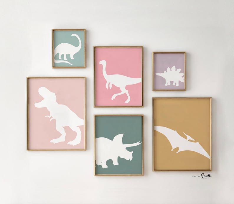 Adorable dinosaur art prints designed for a little girls room, featuring playful dinosaurs in shades of pink, teal, and purple. These vibrant and fun dinosaur illustrations are perfect for adding a touch of adventure and charm to toddler wall decor. Ideal for a girl's nursery, bedroom, or playroom, these art prints create a whimsical and colorful space. Perfect for girls who love dinosaurs, this wall decor adds personality and joy to any room setting, making it a delightful addition to her space