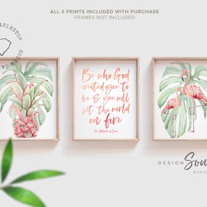 May include: Three framed watercolor prints. The left print features a pineapple with tropical leaves. The center print has the text "Be who God created you to be & you will set the world on fire." The right print shows two flamingos. The prints are in wooden frames.
