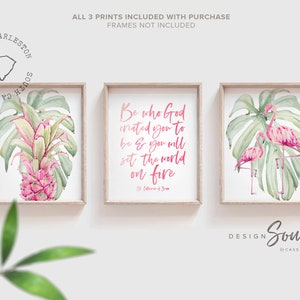 May include: Three framed prints with a tropical theme. The prints feature pink flamingos, green monstera leaves, and a pink pineapple. The center print has a pink quote that reads 'Be who God created you to be & you will set the world on fire.' The quote is attributed to St. Catherine of Siena.