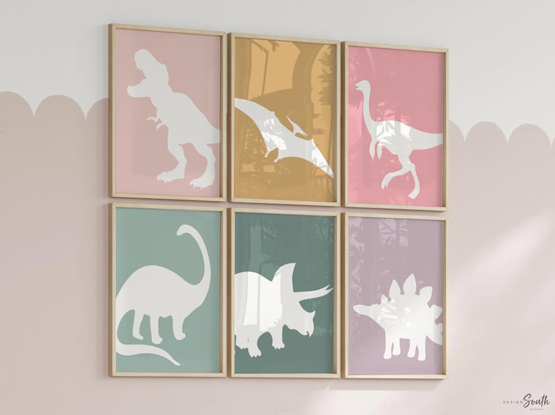 Adorable dinosaur art prints designed for a little girls room, featuring playful dinosaurs in shades of pink, teal, and purple. These vibrant and fun dinosaur illustrations are perfect for adding a touch of adventure and charm to toddler wall decor. Ideal for a girl's nursery, bedroom, or playroom, these art prints create a whimsical and colorful space. Perfect for girls who love dinosaurs, this wall decor adds personality and joy to any room setting, making it a delightful addition to her space