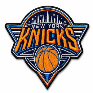 May include: An embroidered patch featuring the New York Knicks logo with a basketball graphic, the text NEW YORK KNICKS in orange, and a white skyline silhouette against a dark blue background with orange and white border accents.