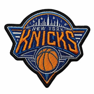 May include: An embroidered patch featuring the New York Knicks logo with a blue, orange, and white color scheme. The design includes a basketball graphic, a stylized New York City skyline silhouette, and the text NEW YORK KNICKS in bold lettering.
