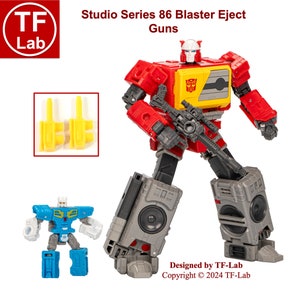 May include: Studio Series 86 Blaster Eject Guns Transformer action figure. The figure is red, yellow, and gray with a black gun. The figure is in robot mode and has a cassette player on its legs. The figure is designed by TF-Lab and copyrighted 2024 TF-Lab.