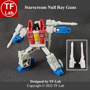 May include: Starscream action figure with red, white, and blue paint, holding two white Null Ray Guns. The figure is in a robot pose with one leg raised. The image includes the text "Starscream Null Ray Guns" and "Designed by TF-Lab Copyright © 2022 TF-Lab".