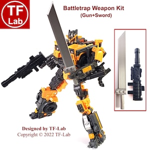 May include: A black and yellow robot toy holding a silver sword and a black gun. The toy is labeled "Battletrap Weapon Kit (Gun+Sword)" and "Designed by TF-Lab Copyright © 2022 TF-Lab".