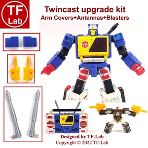 May include: Twincast upgrade kit for Transformers action figures. The kit includes blue arm covers, yellow antennas, and gray blasters. The kit is designed by TF-Lab and includes the text "Twincast upgrade kit Arm Covers+Antennas+Blasters Designed by TF-Lab Copyright © 2022 TF-Lab".
