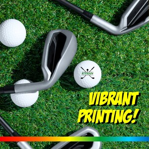May include: Golf balls with a vibrant print design on a green grass background. The text "ETHAN" and a golf club design are printed on one of the golf balls. The text "VIBRANT PRINTING!" is printed in yellow on a black background.